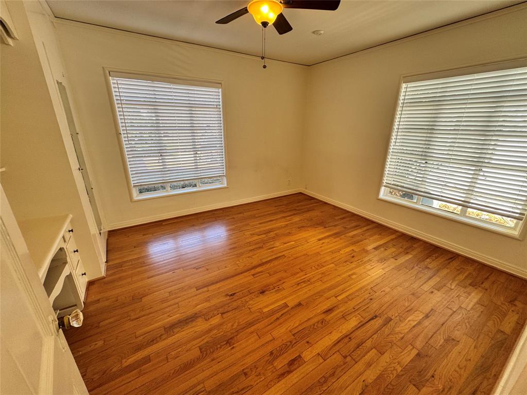 3727 Meredith Avenue Dallas, TX 75211 - Photo 12 of 17 a view of an empty room with window and wooden floor