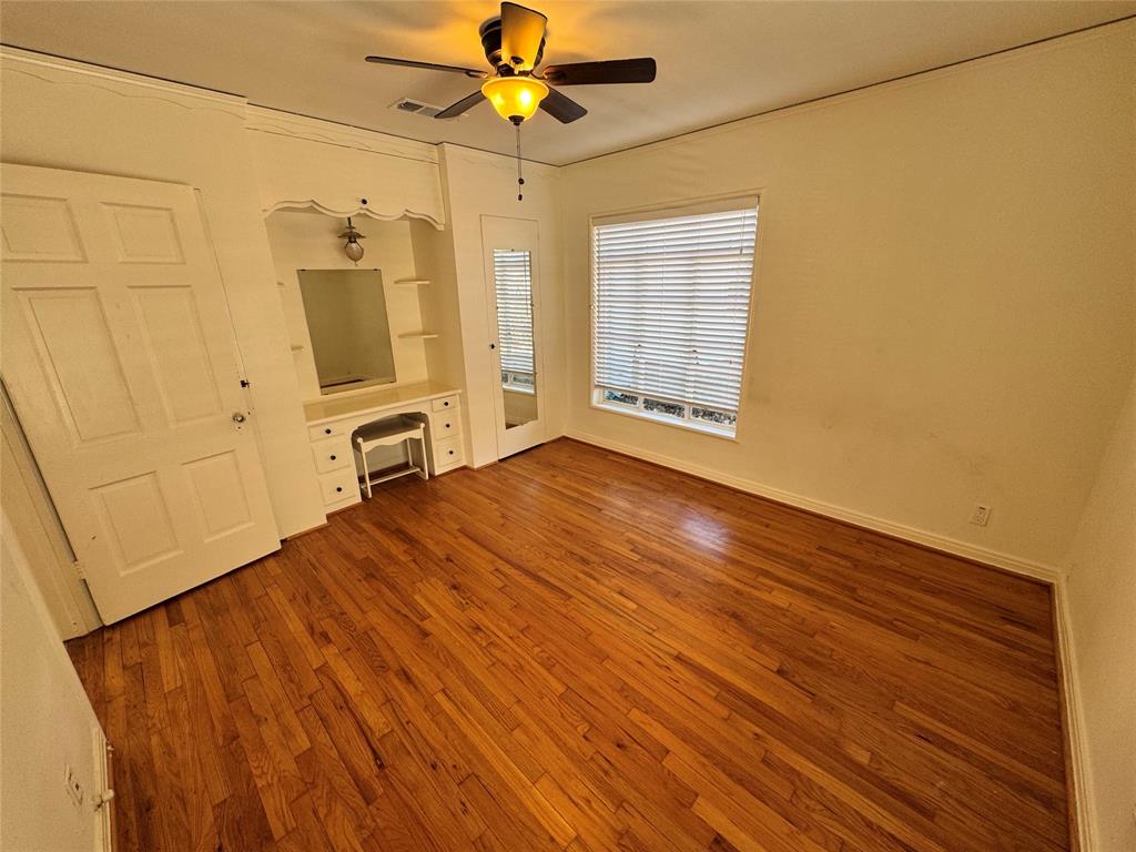 3727 Meredith Avenue Dallas, TX 75211 - Photo 13 of 17 a view of empty room with wooden floor and fan