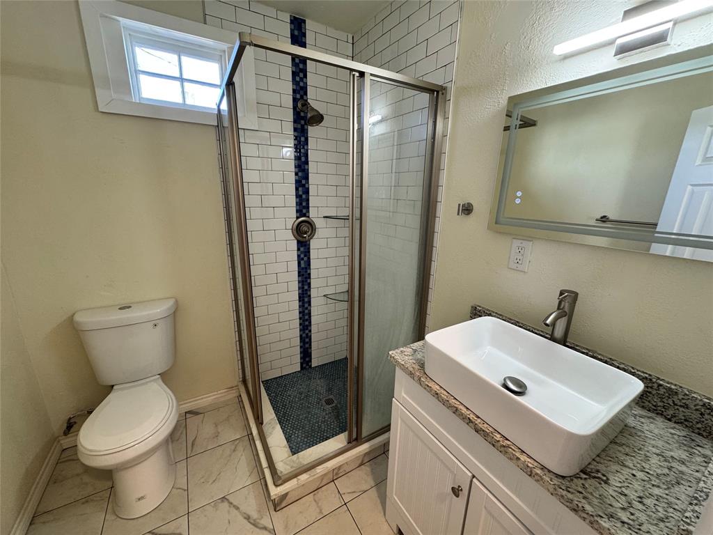 3727 Meredith Avenue Dallas, TX 75211 - Photo 14 of 17 a bathroom with a sink toilet and shower