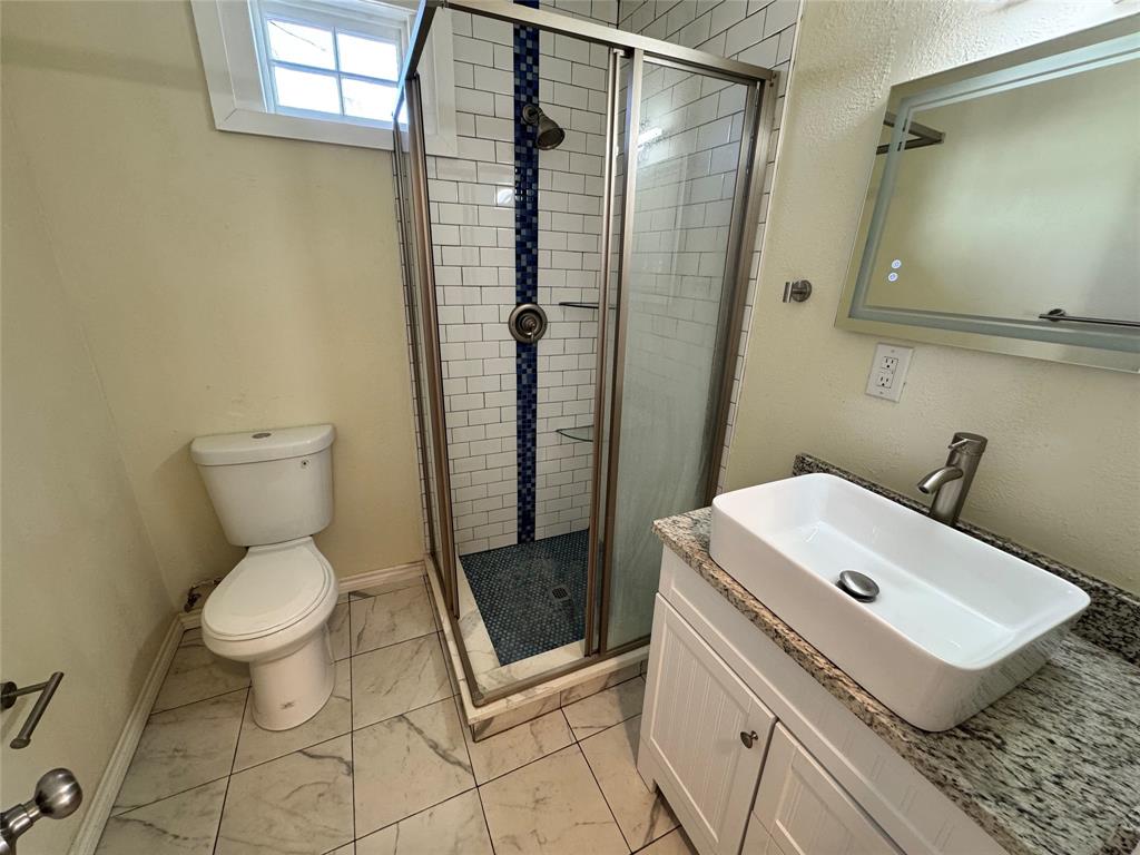 3727 Meredith Avenue Dallas, TX 75211 - Photo 15 of 17 a bathroom with a sink toilet and shower