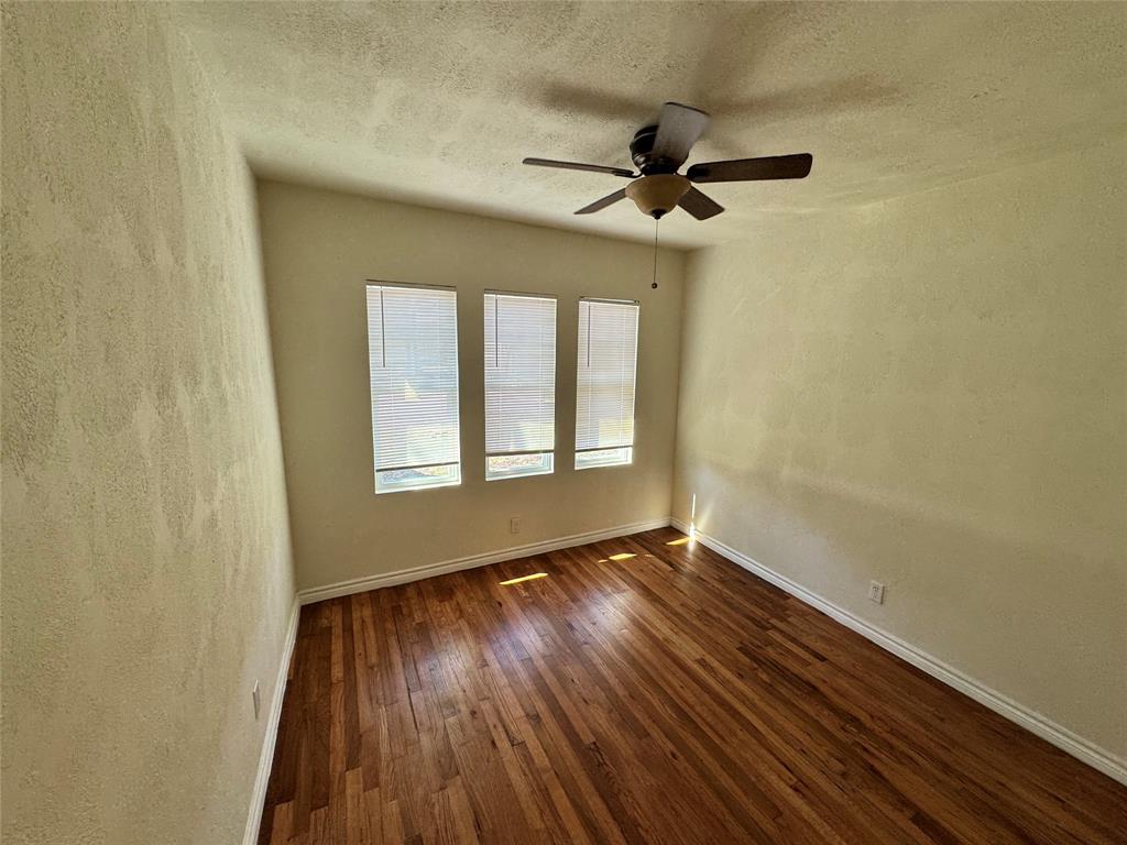 3727 Meredith Avenue Dallas, TX 75211 - Photo 16 of 17 a view of an empty room with wooden floor and a window