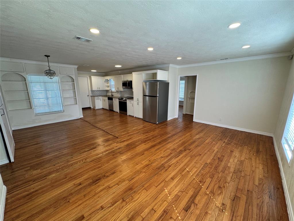 3727 Meredith Avenue Dallas, TX 75211 - Photo 2 of 17 a view of an empty room with kitchen and window