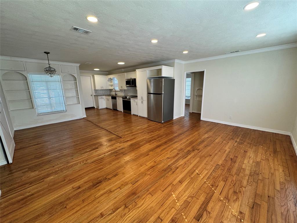 3727 Meredith Avenue Dallas, TX 75211 - Photo 3 of 17 a view of an empty room with kitchen and window