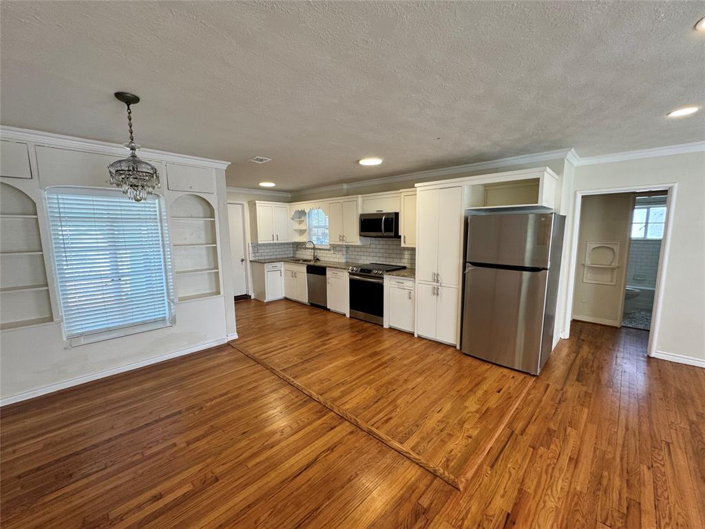 3727 Meredith Avenue Dallas, TX 75211 - Photo 4 of 17 a kitchen with stainless steel appliances granite countertop a refrigerator and a sink
