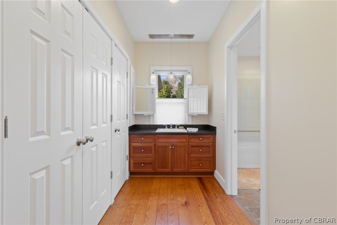 60 York Road Irvington, VA 22480 - Photo 16 of 50 Just down a private hall to the primary bedroom suite with vanity and multiple closets with built-ins