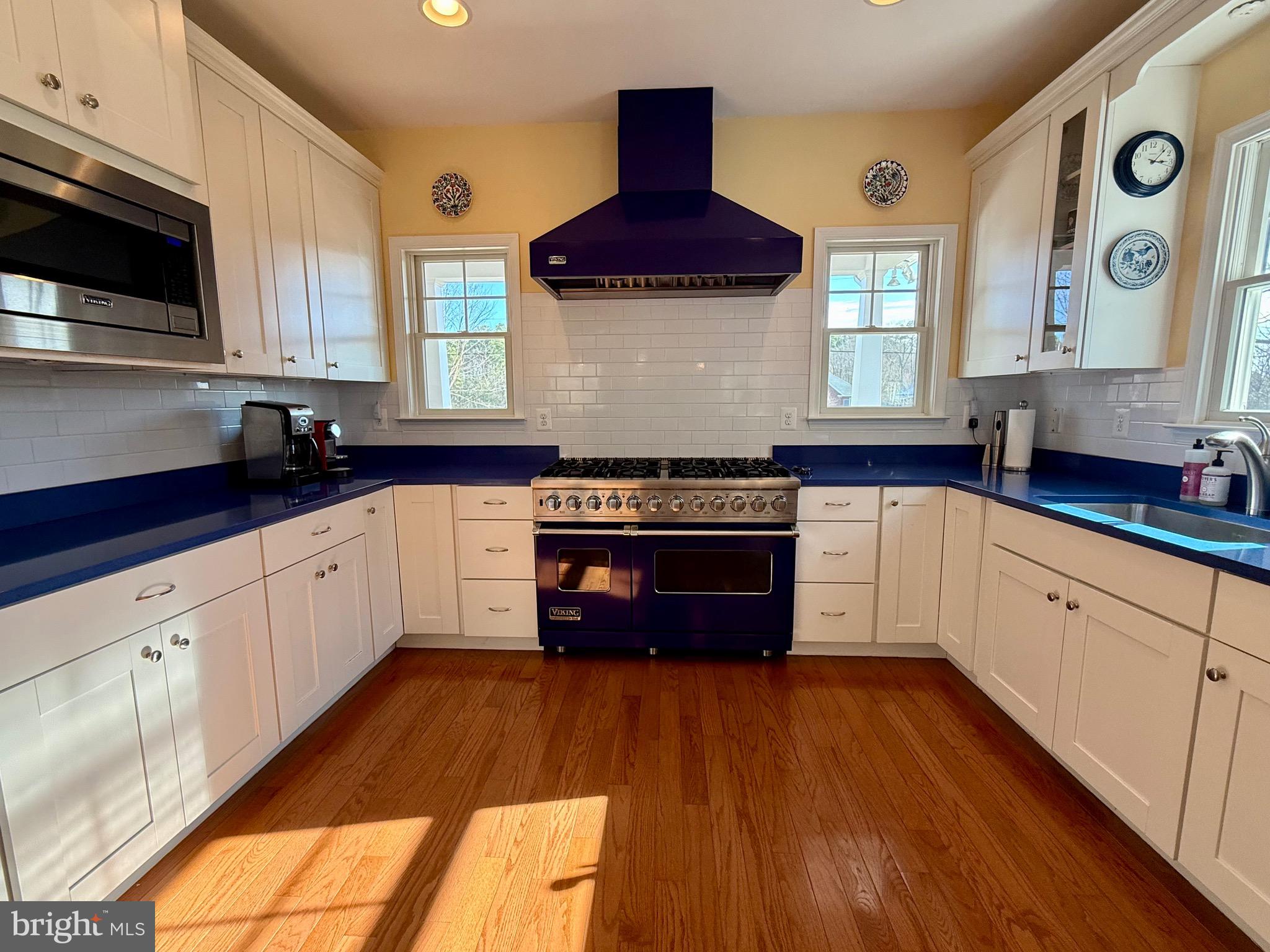 48830 Curleys Road Ridge, MD 20680 - Photo 15 of 65 a kitchen with stainless steel appliances granite countertop wooden cabinets stove top oven and sink