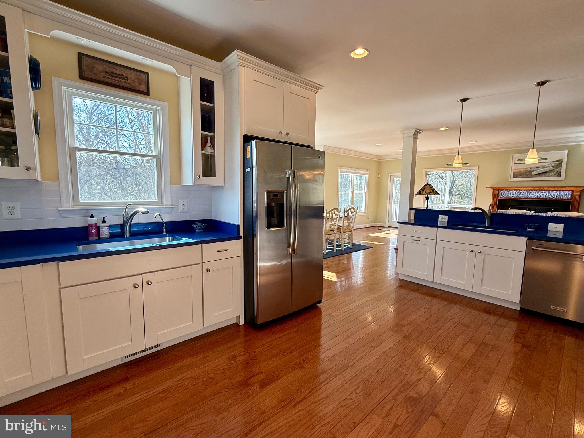 48830 Curleys Road Ridge, MD 20680 - Photo 18 of 65 a large kitchen with stainless steel appliances kitchen island granite countertop a stove a sink a refrigerator and white cabinets with wooden floor