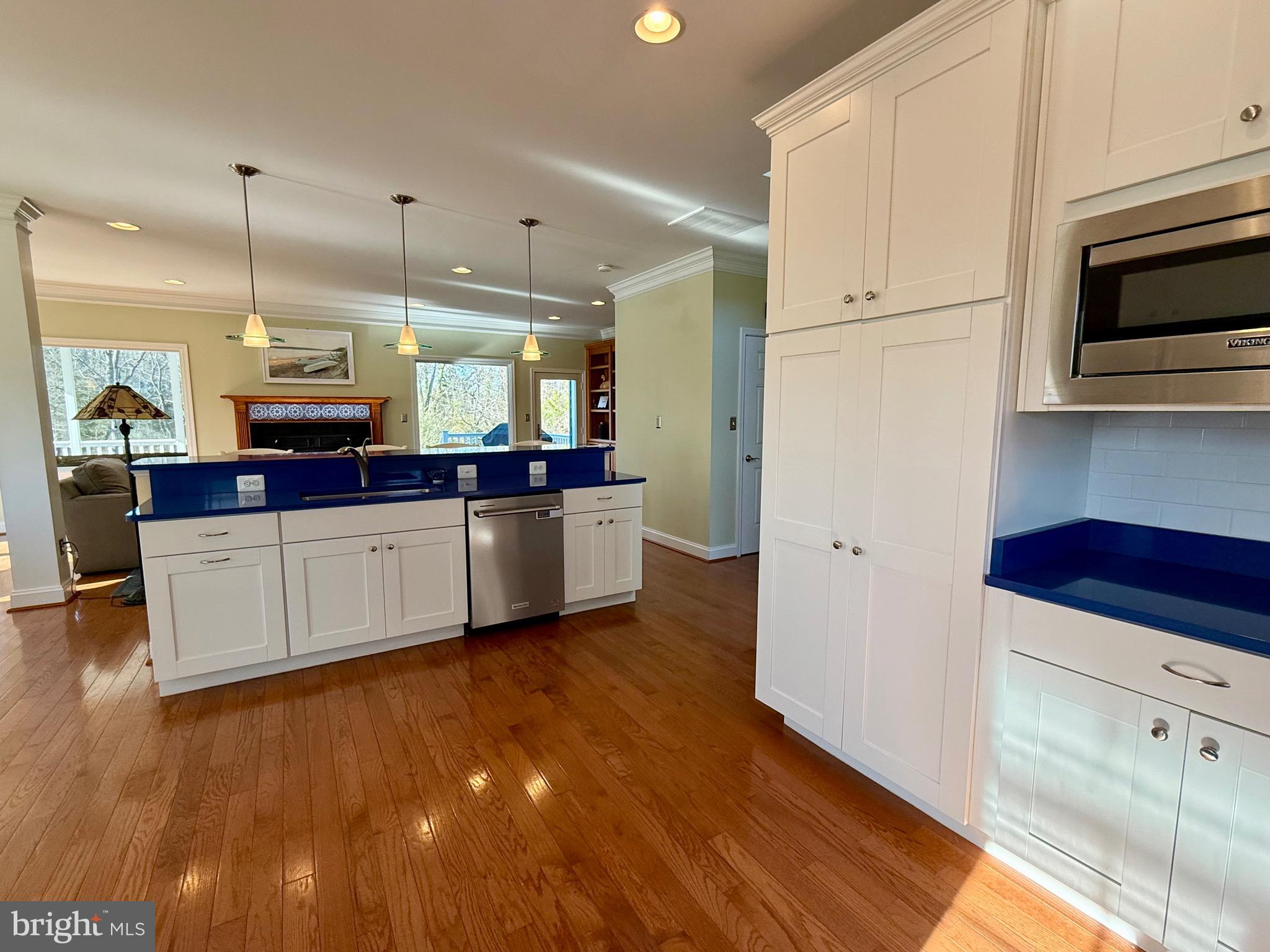 48830 Curleys Road Ridge, MD 20680 - Photo 19 of 65 a large kitchen with stainless steel appliances and white cabinets