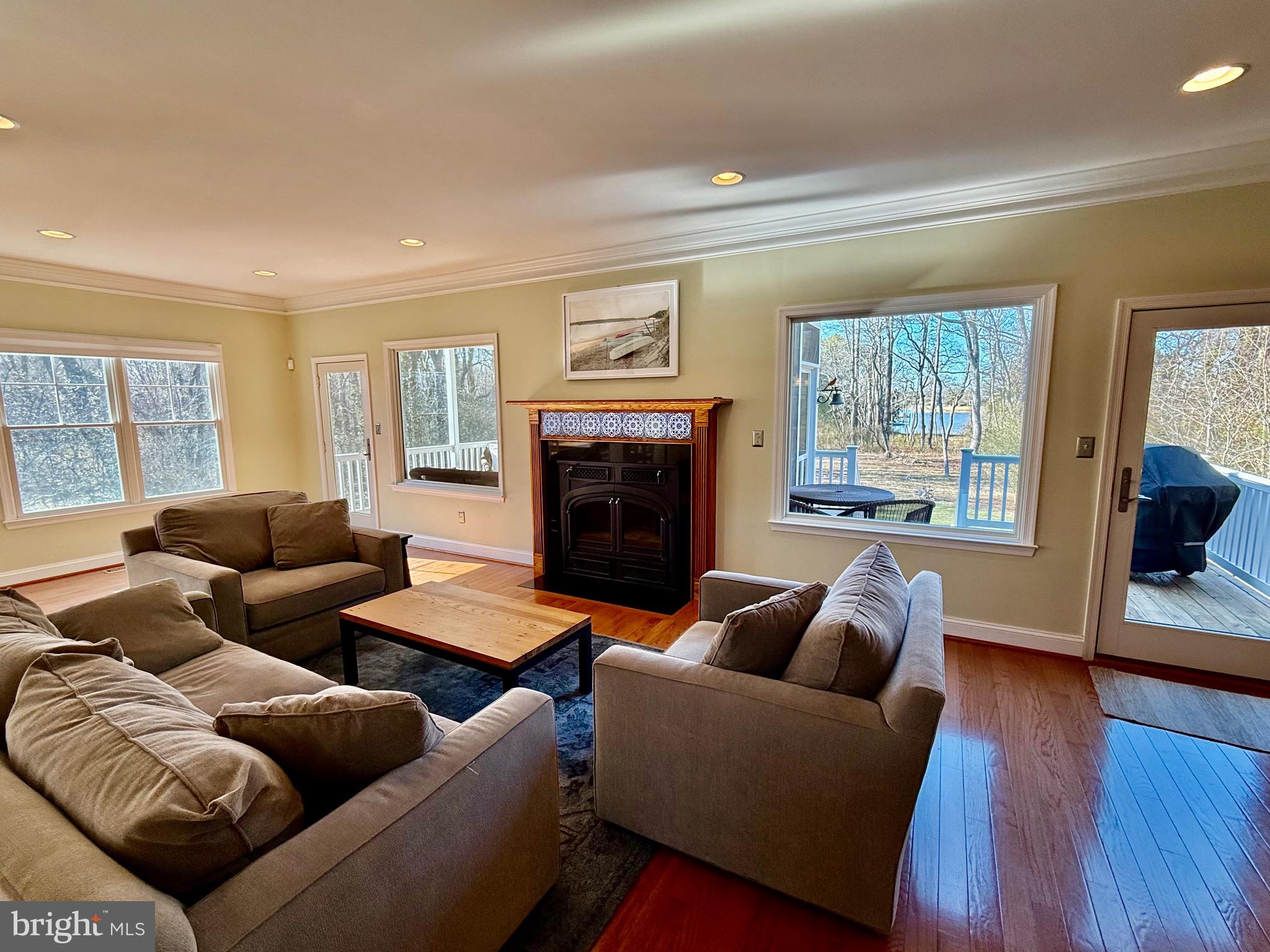48830 Curleys Road Ridge, MD 20680 - Photo 21 of 65 a living room with furniture and a fireplace
