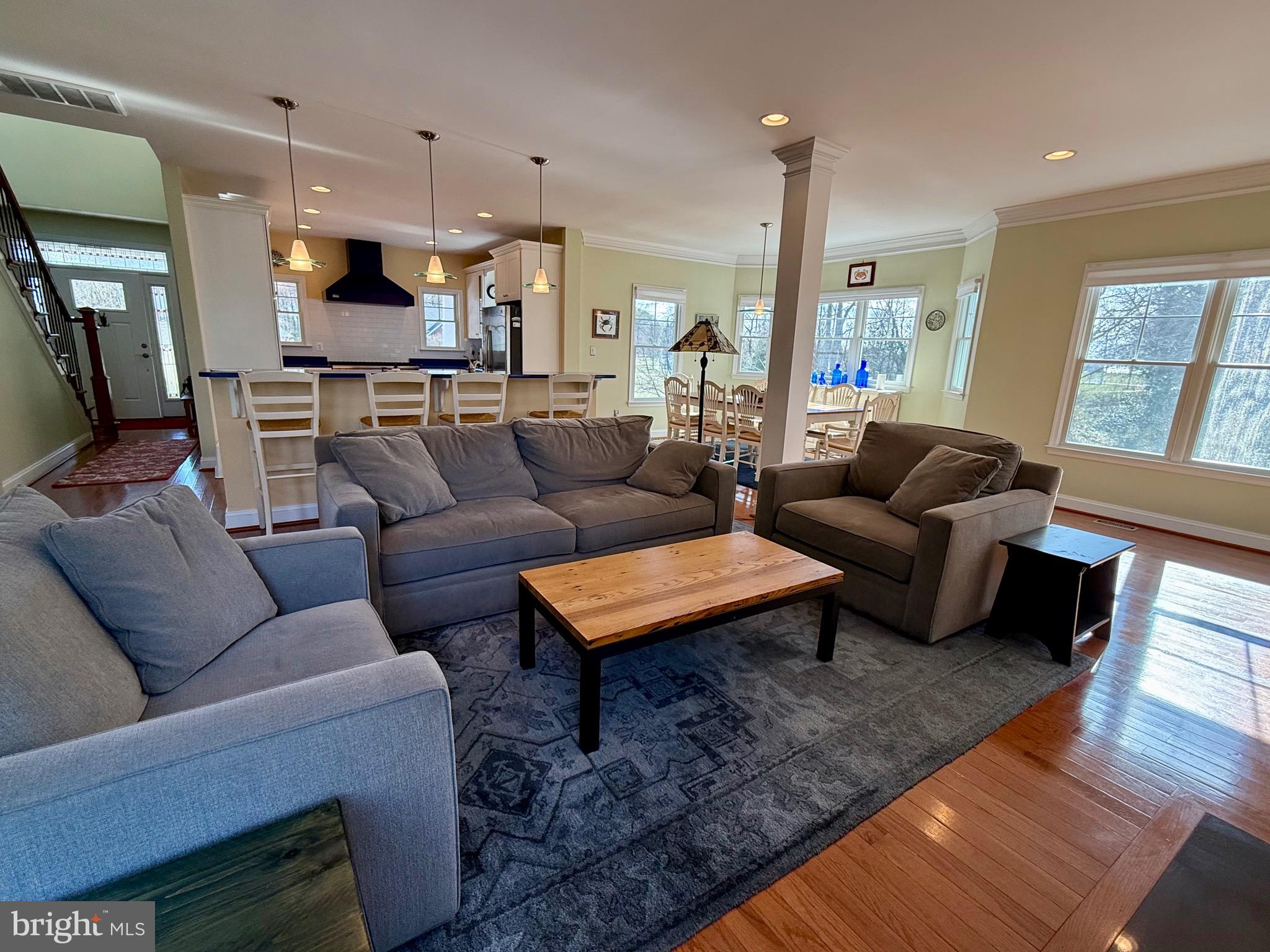 48830 Curleys Road Ridge, MD 20680 - Photo 22 of 65 a living room with furniture wooden floor and a large window