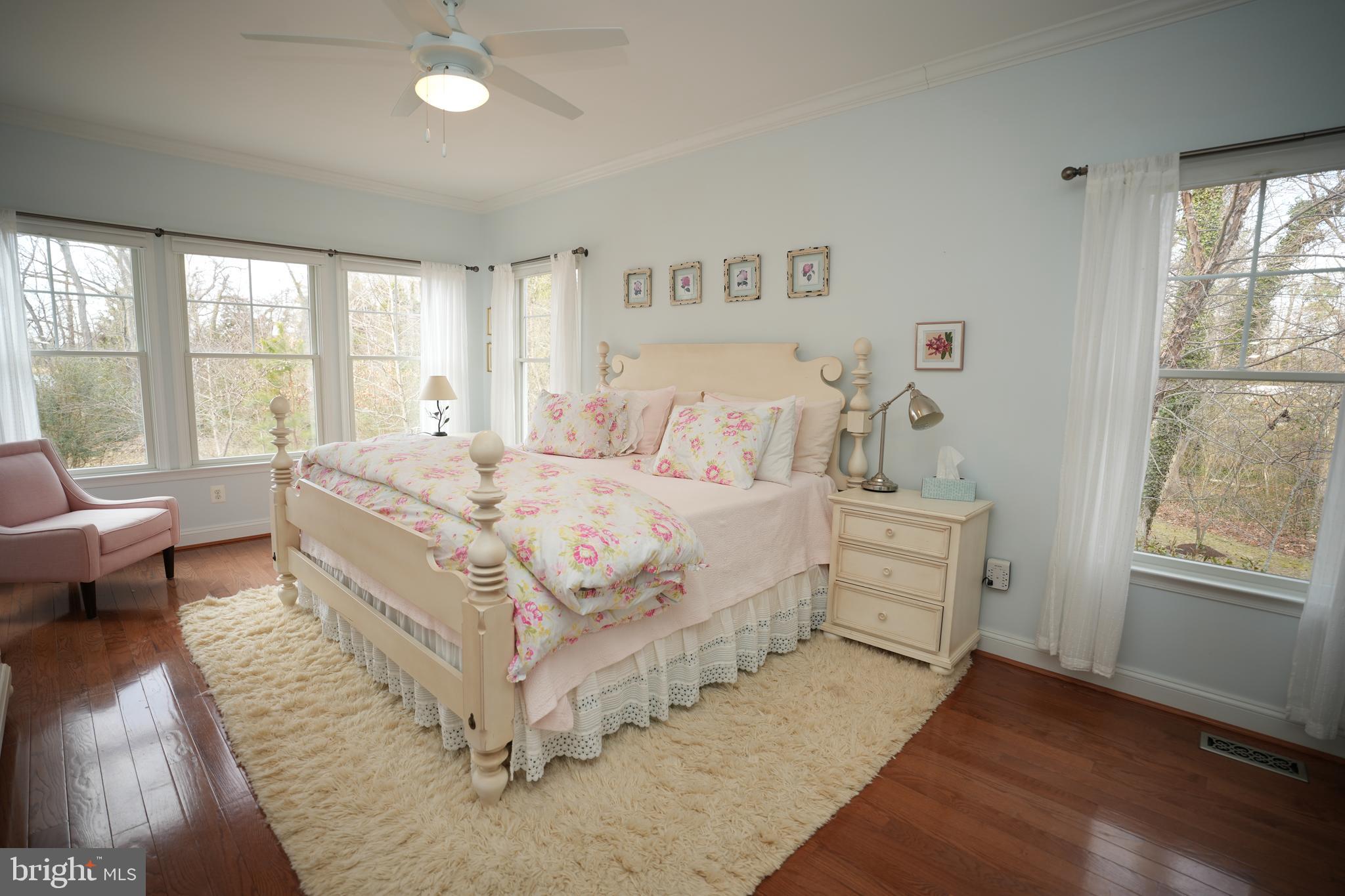 48830 Curleys Road Ridge, MD 20680 - Photo 29 of 65 a bed room with a bed couch and a large window