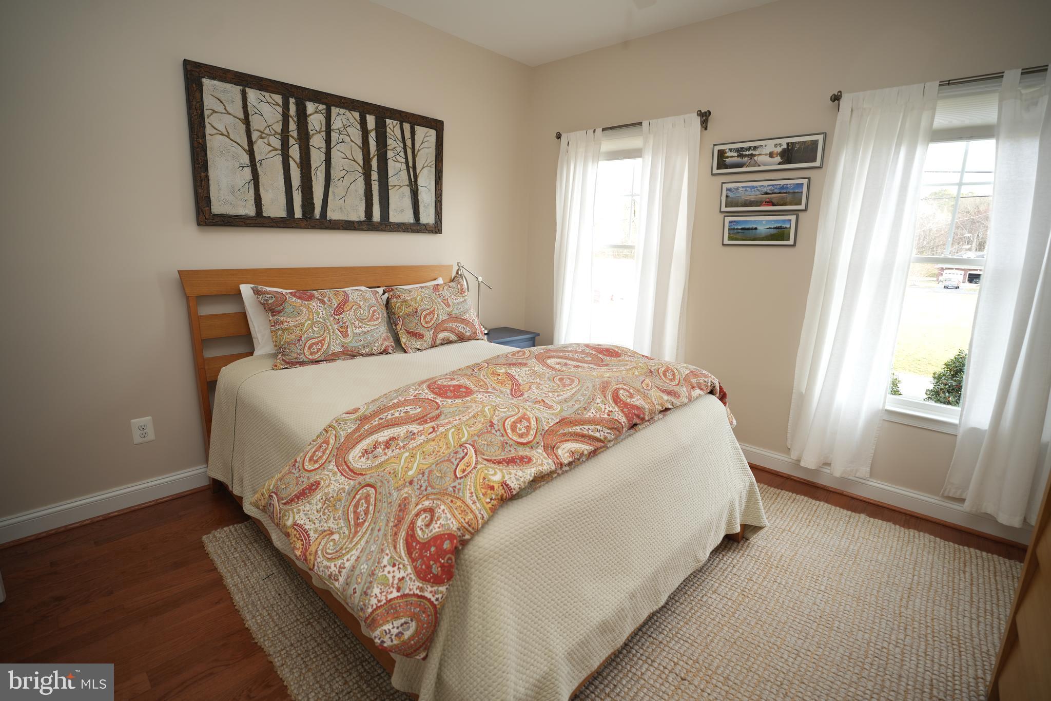 48830 Curleys Road Ridge, MD 20680 - Photo 31 of 65 a large bed sitting in a bedroom next to a window