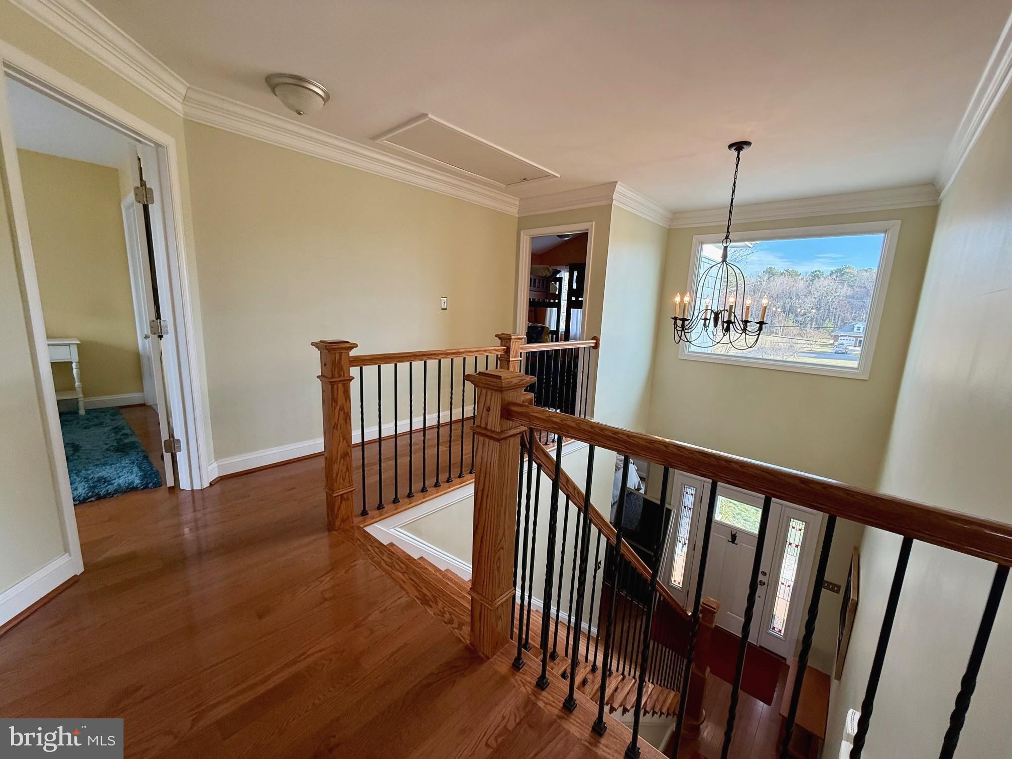 48830 Curleys Road Ridge, MD 20680 - Photo 35 of 65 a view of a hallway with wooden floor and stairs