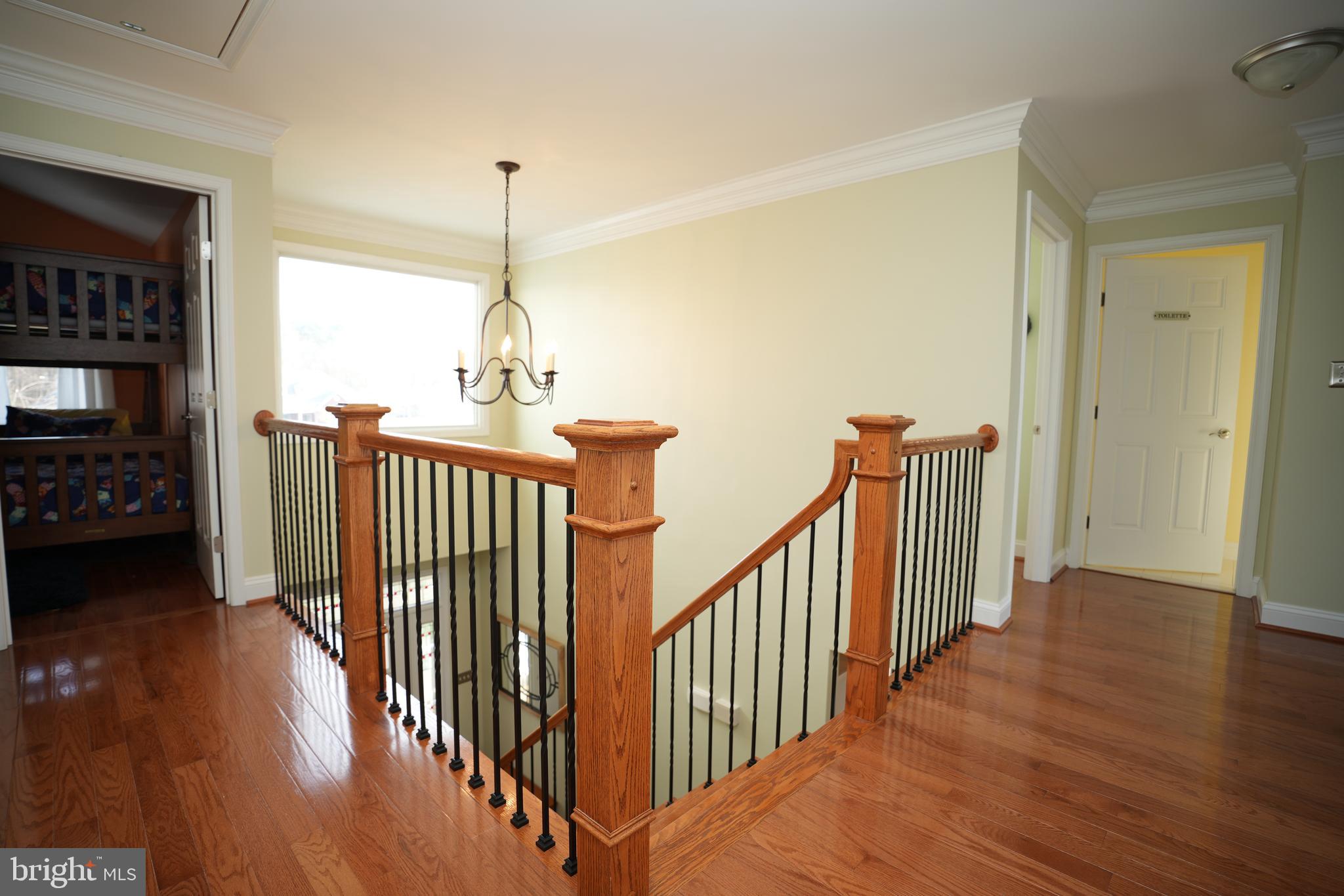 48830 Curleys Road Ridge, MD 20680 - Photo 36 of 65 a view of a hallway with wooden floor and windows