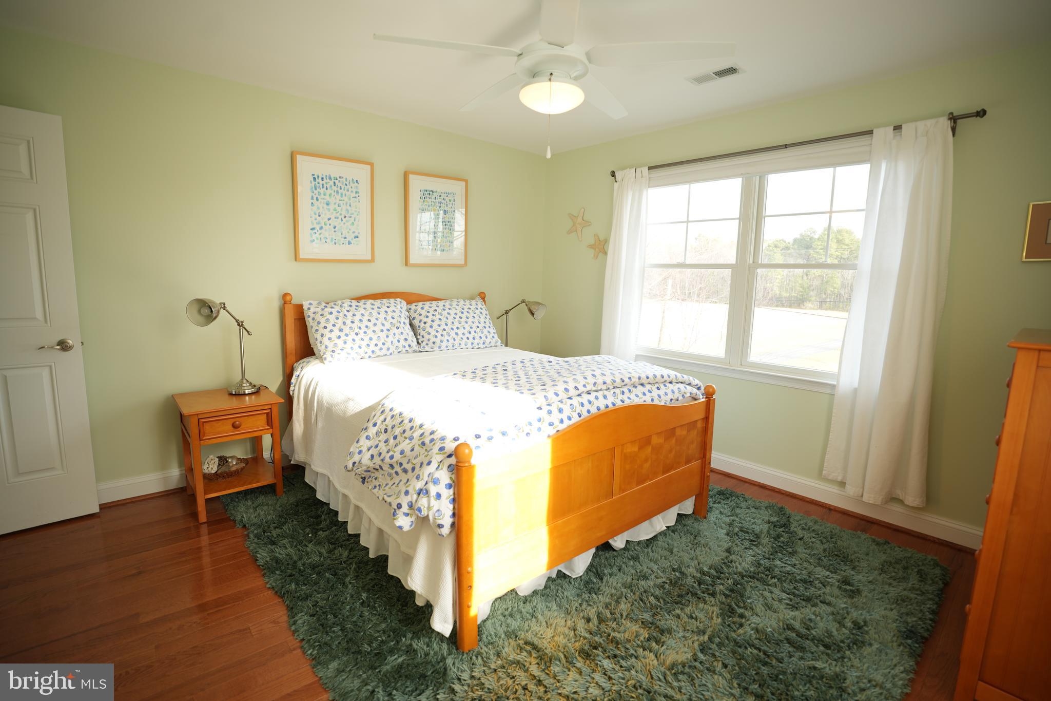48830 Curleys Road Ridge, MD 20680 - Photo 40 of 65 a bedroom with a bed and a window