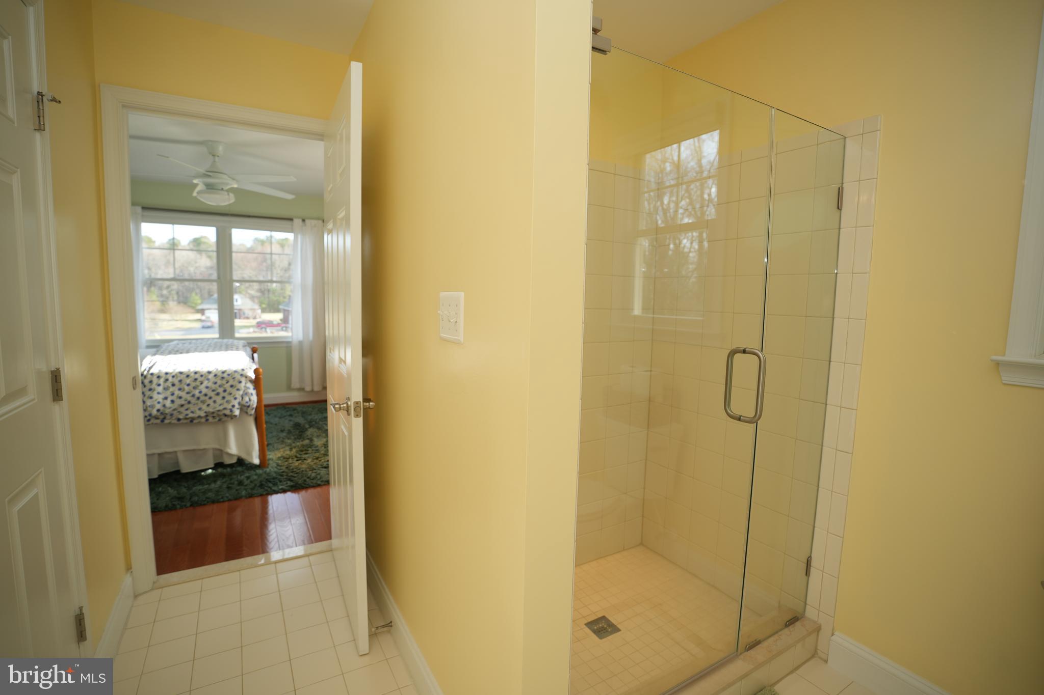 48830 Curleys Road Ridge, MD 20680 - Photo 42 of 65 a bathroom with a glass shower door