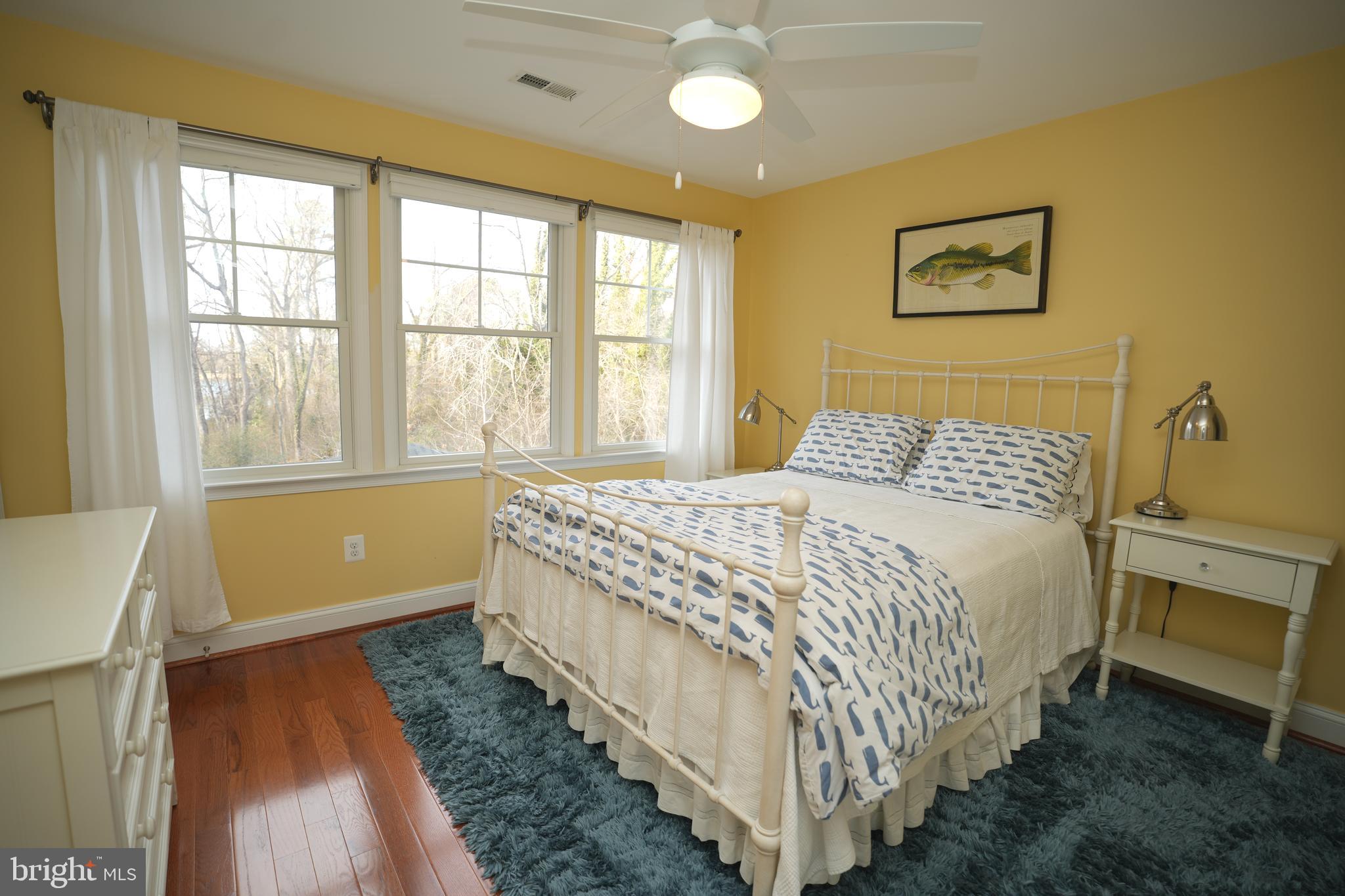 48830 Curleys Road Ridge, MD 20680 - Photo 44 of 65 a bedroom with a bed and a large window