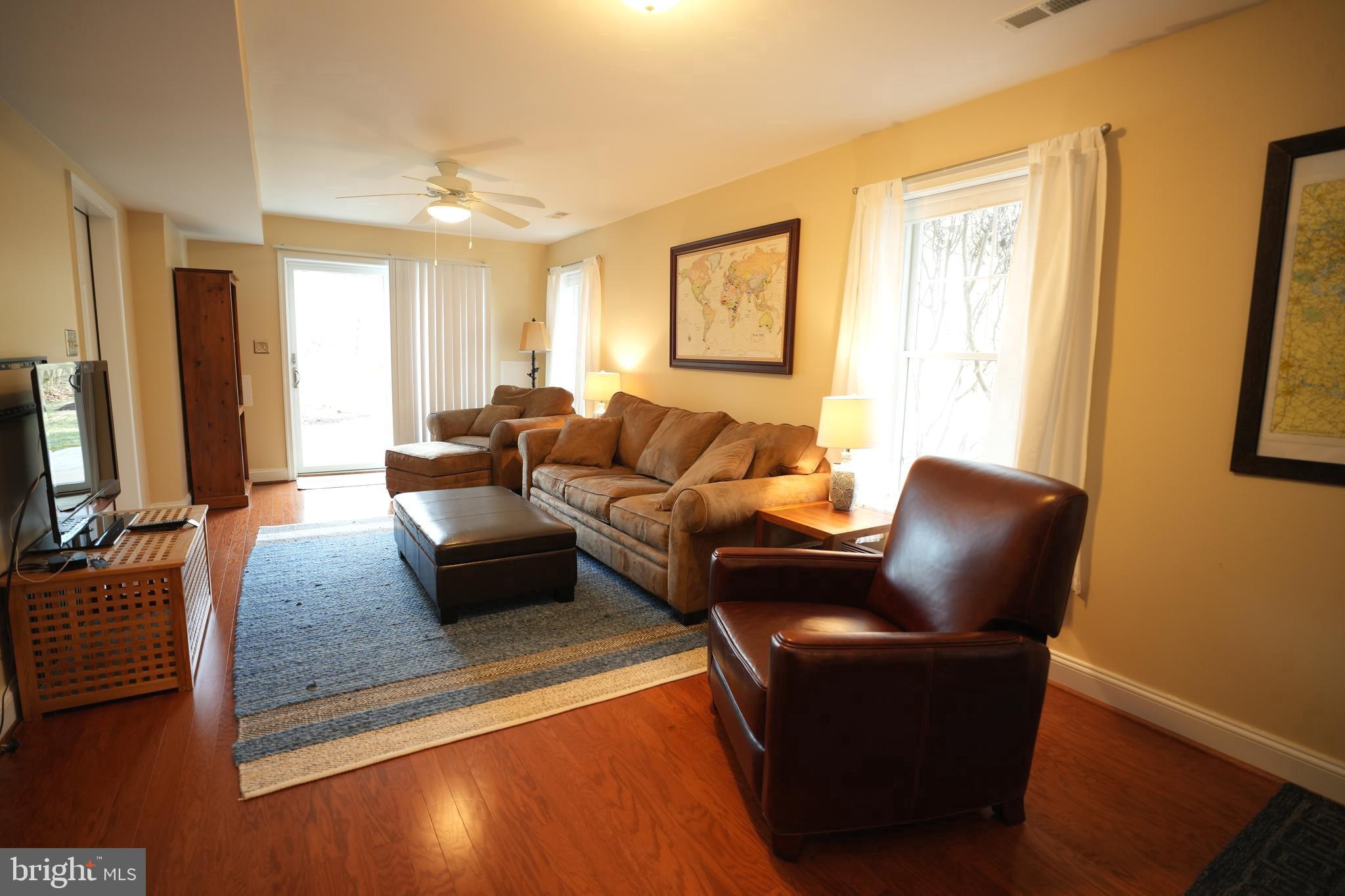48830 Curleys Road Ridge, MD 20680 - Photo 49 of 65 a living room with furniture and a flat screen tv
