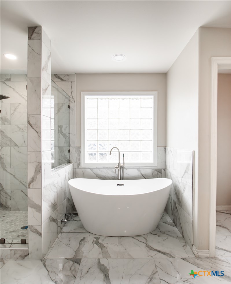 202 Ridge View Victoria, TX 77904 - Photo 5 of 37 a white bath tub sitting in a spacious bathroom next to a window