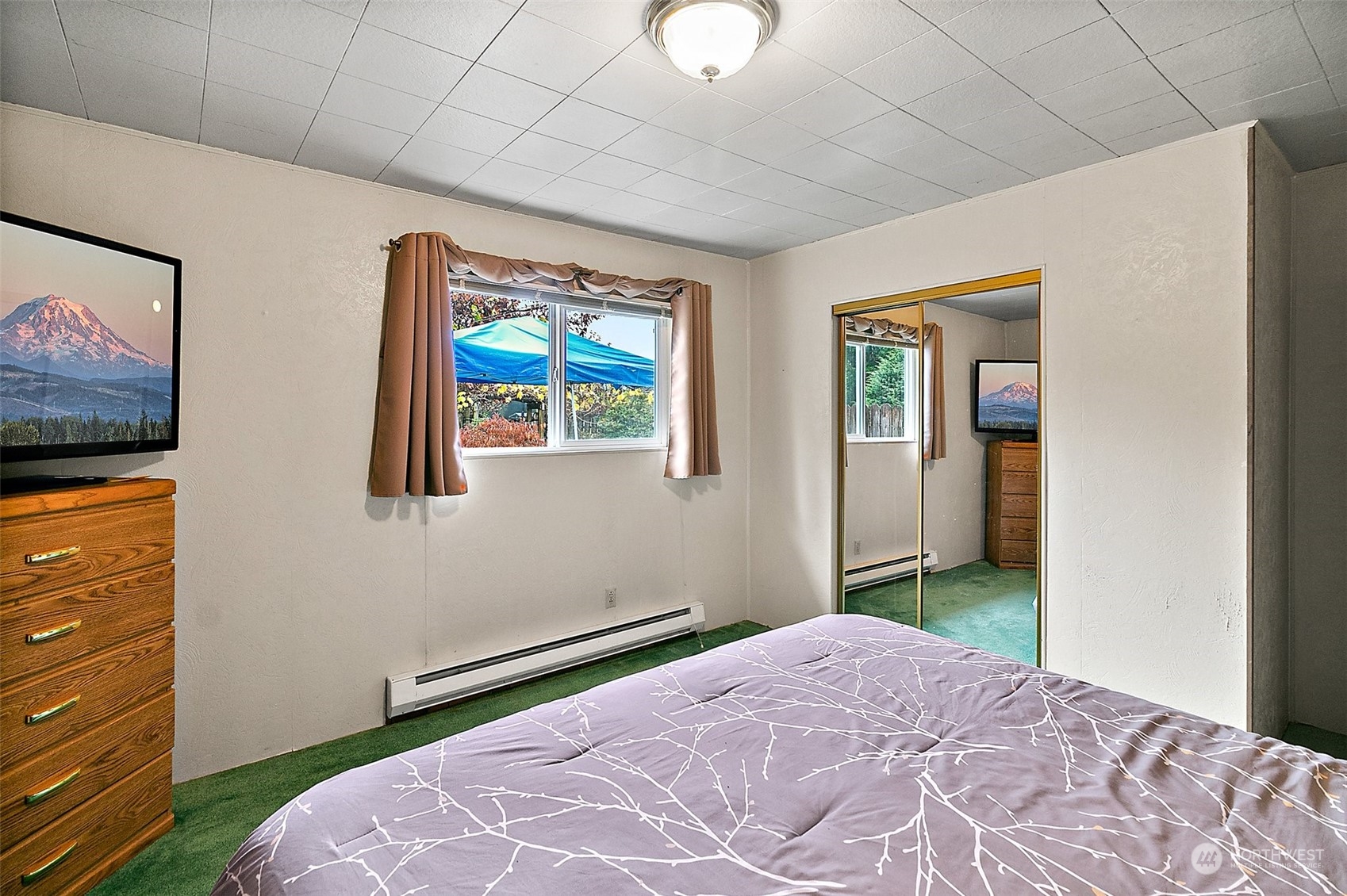 7639 191st Avenue Southwest Rochester, WA 98579 - Photo 9 of 40 a bedroom with a bed and a flat screen tv