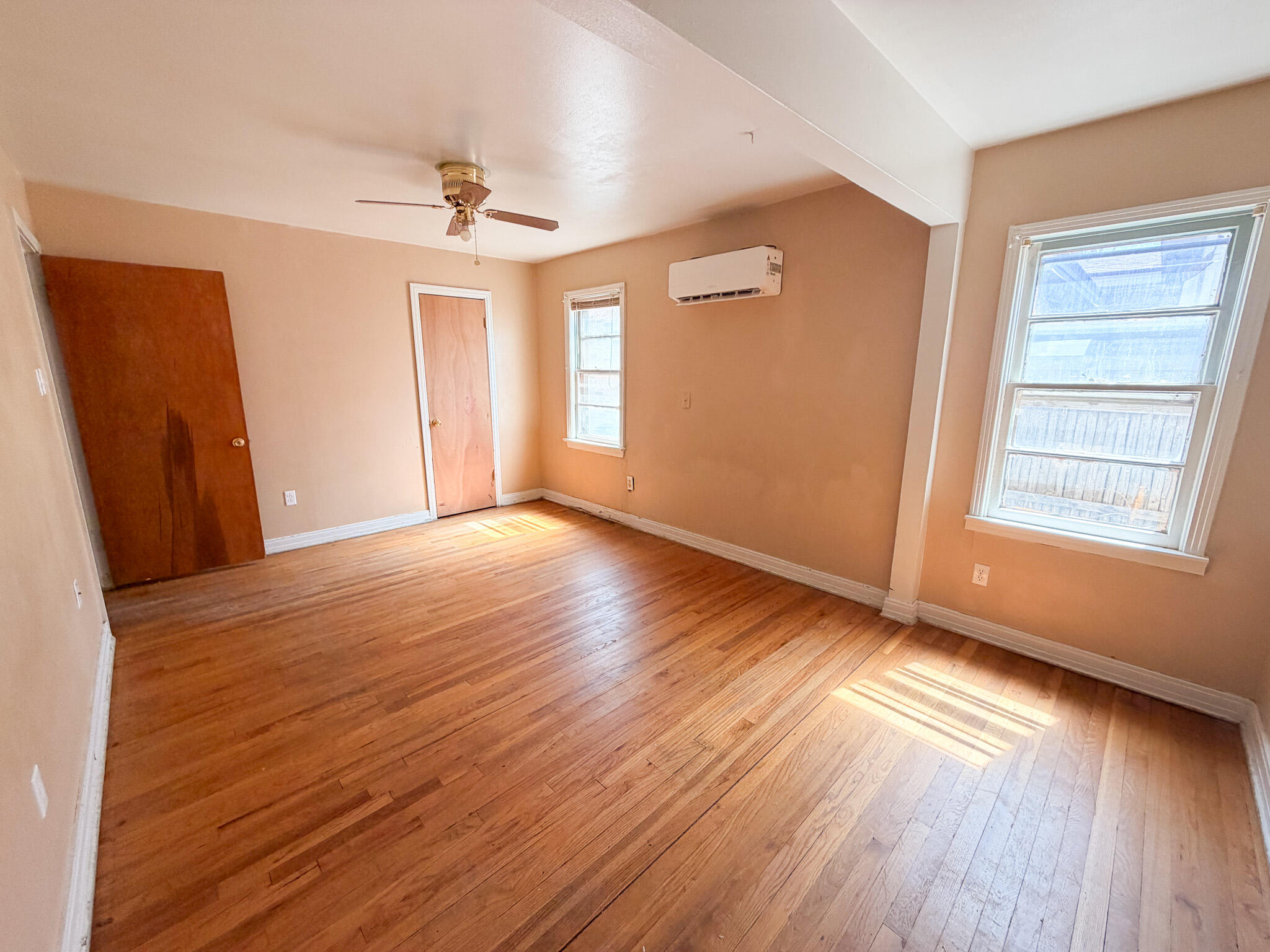 3207 Amherst Street Lubbock, TX 79415 - Photo 7 of 16 a view of an empty room with wooden floor and a window