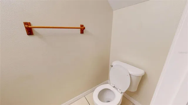 a white toilet sitting next to a shower