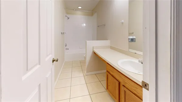 a spacious bathroom with a granite countertop sink a mirror and a shower