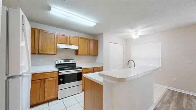 a kitchen with a sink cabinets and appliances