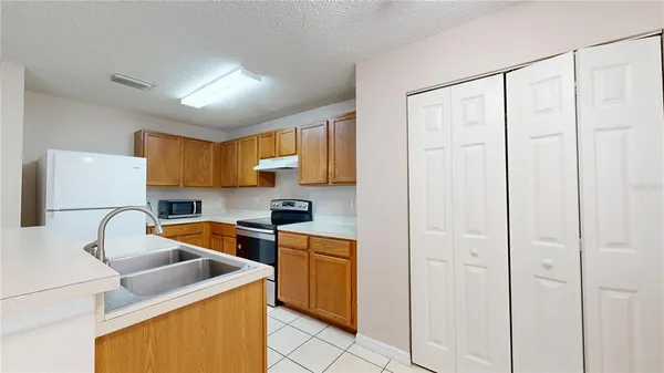 a utility room with cabinets washer and dryer