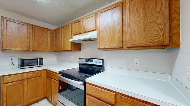 a kitchen with stainless steel appliances a stove a microwave and cabinets