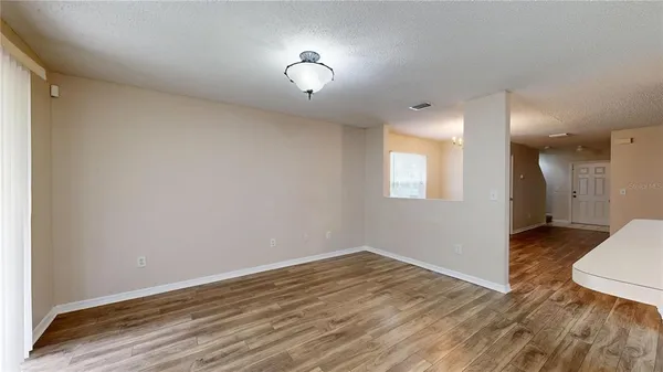 a view of a room with wooden floor and a sink