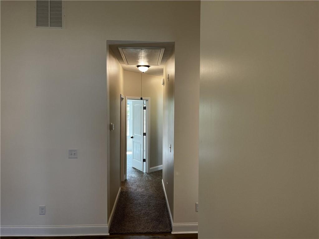 1932 Cochran Ridge Road Hiram, GA 30141 - Photo 15 of 30 a view of a hallway with wooden floor and a bathroom