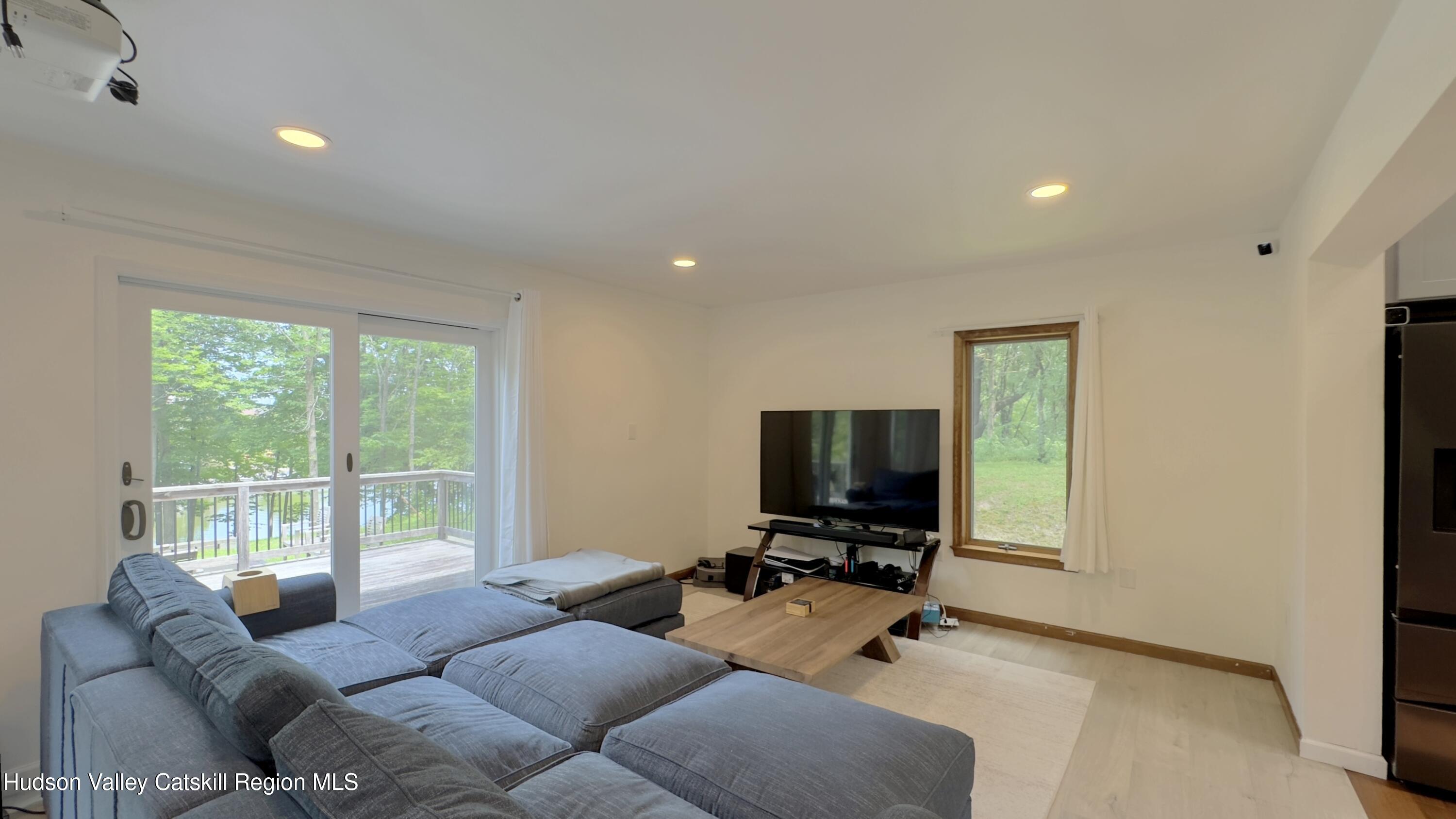 3223 Sleepy Hollow Road Athens, NY 12015 - Photo 16 of 73 a living room with furniture windows and a flat screen tv