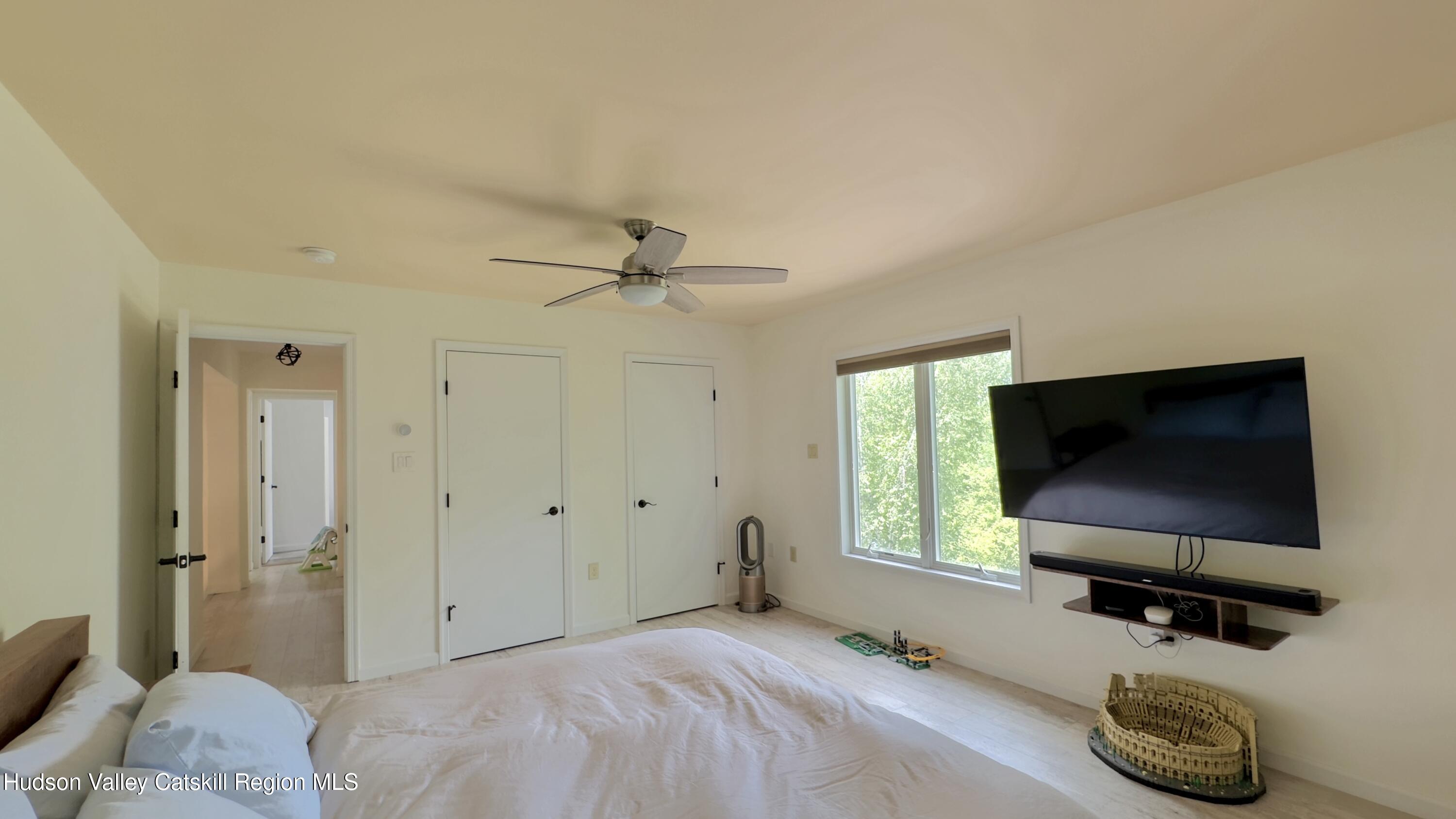 3223 Sleepy Hollow Road Athens, NY 12015 - Photo 25 of 73 a bedroom with a bed and a flat screen tv