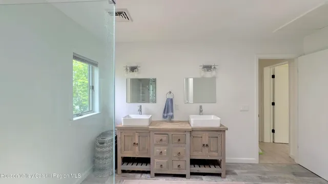 a view of room with wooden floor and windows