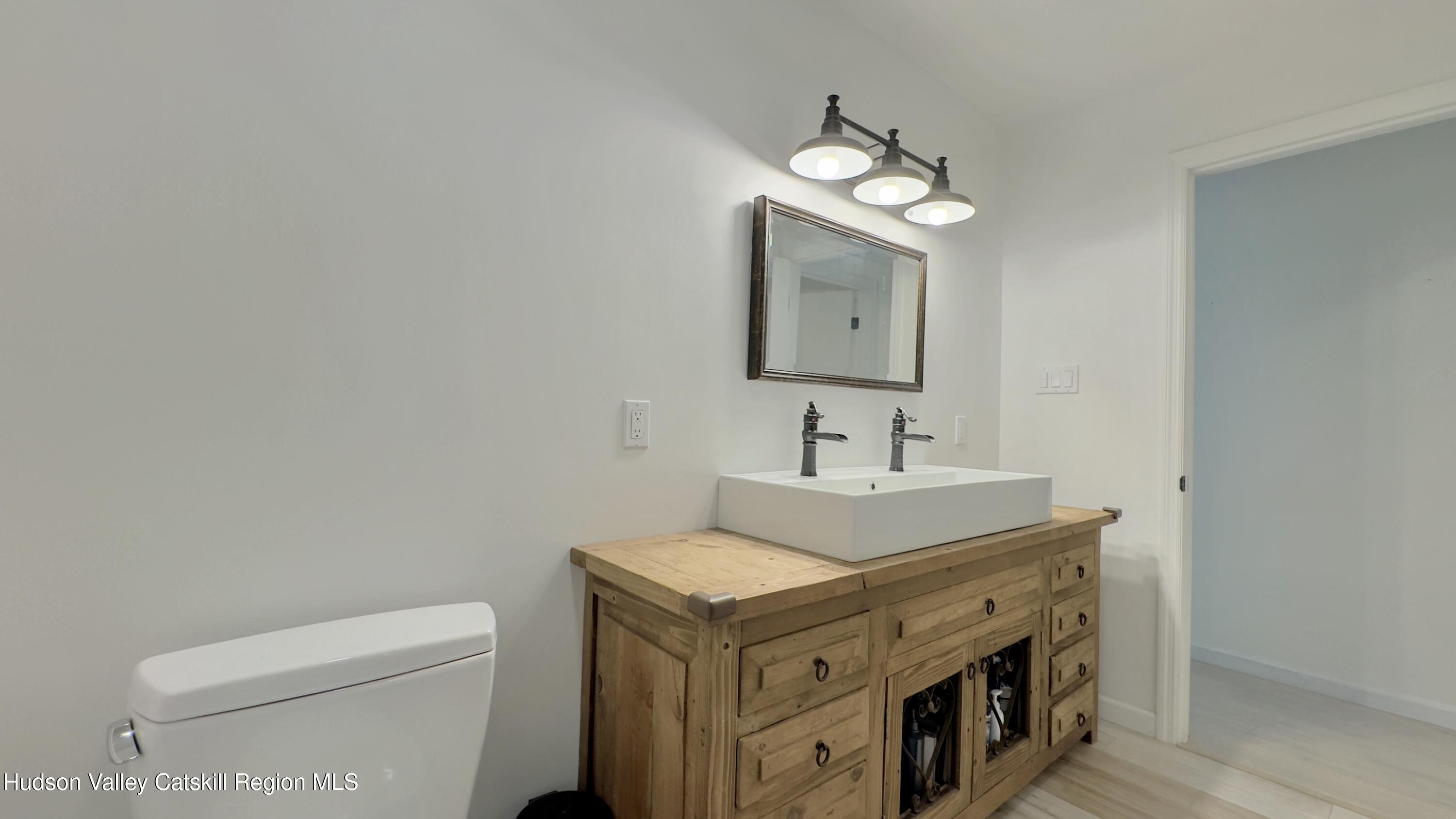 3223 Sleepy Hollow Road Athens, NY 12015 - Photo 34 of 73 a bathroom with a toilet sink and mirror