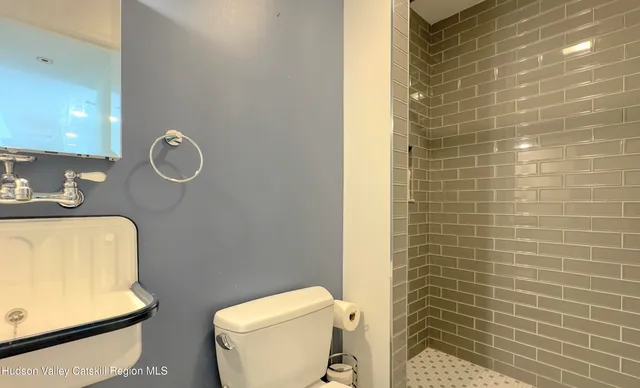 an aerial view of a house with outdoor space and trees all around