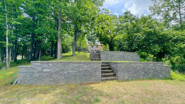 a backyard of a house with table and chairs