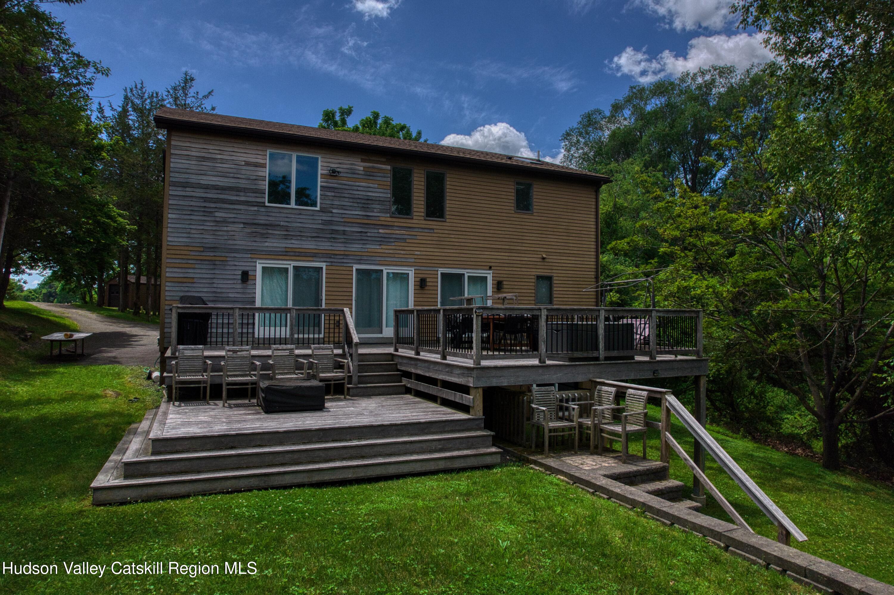 3223 Sleepy Hollow Road Athens, NY 12015 - Photo 57 of 73 a view of a house with backyard sitting area and garden