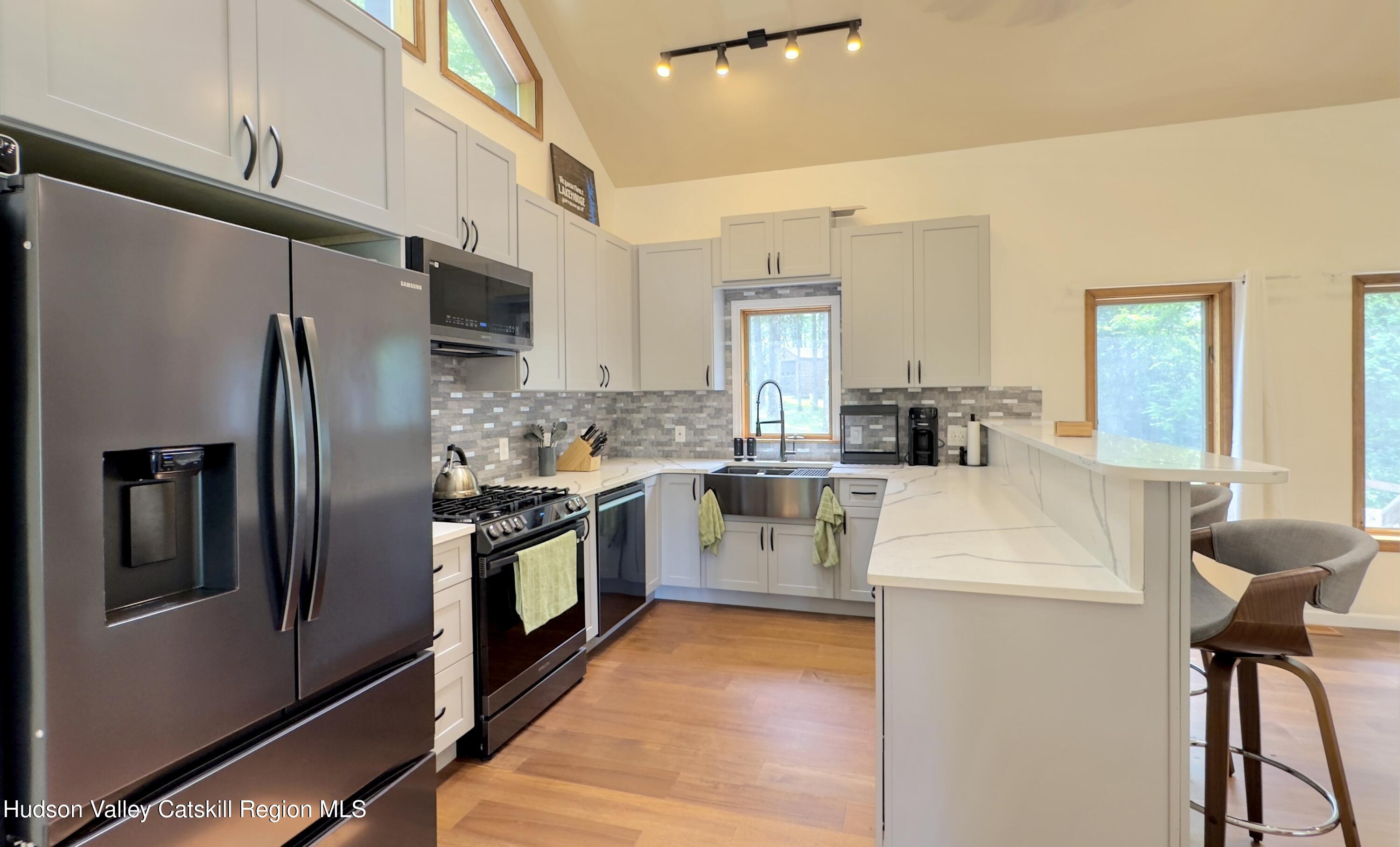 3223 Sleepy Hollow Road Athens, NY 12015 - Photo 10 of 73 a kitchen with stainless steel appliances a refrigerator sink and white cabinets