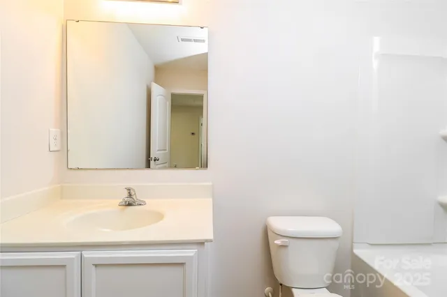a bathroom with a sink toilet and vanity