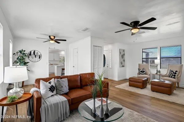 a living room with furniture a window and a table