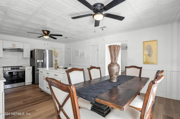 a kitchen with refrigerator cabinets and wooden floor