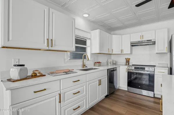 a kitchen with a sink stove and refrigerator