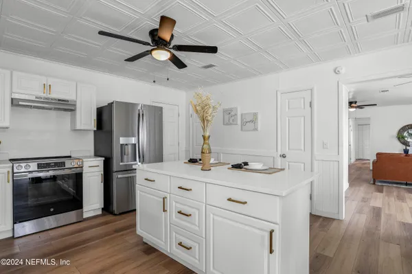 a kitchen with stainless steel appliances granite countertop a stove and a refrigerator