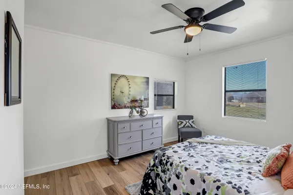 a bedroom with a bed and a painting on the wall