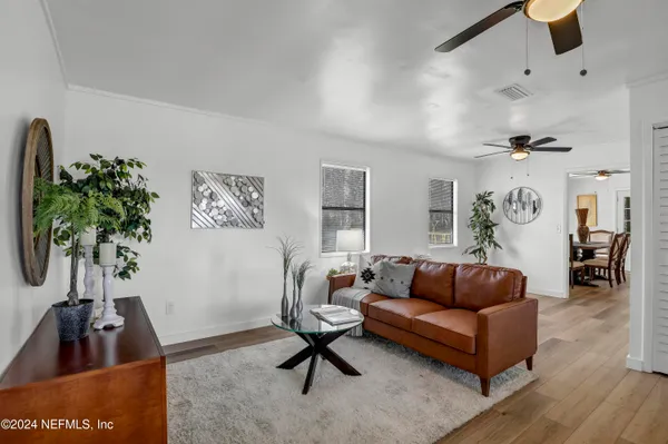 a living room with furniture and a potted plant