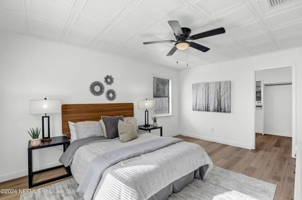 a kitchen with a sink cabinets and wooden floor