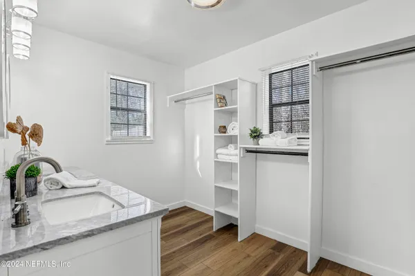 a bathroom with a double vanity sink a mirror and shower