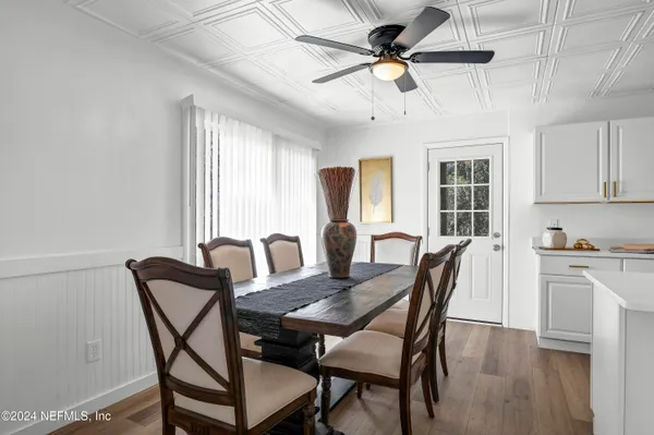 a view of a dining room with furniture window and wooden floor